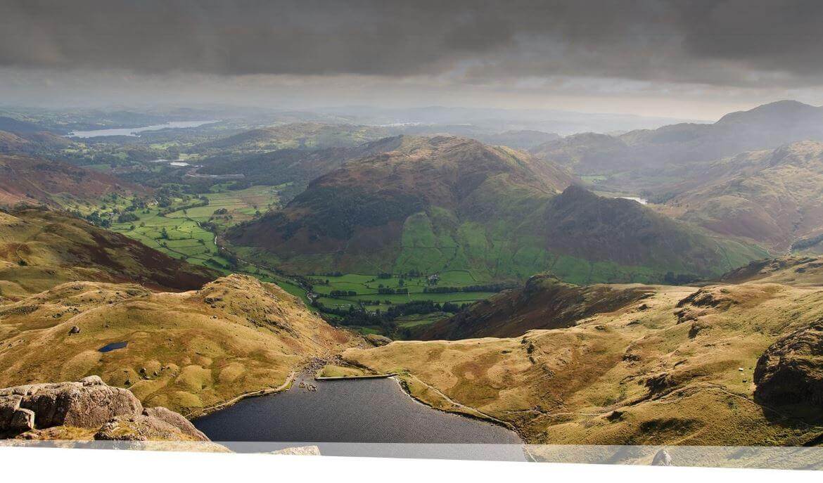 Image of mountains and a lake overlooking Stickle tarn and Langdale Valley.